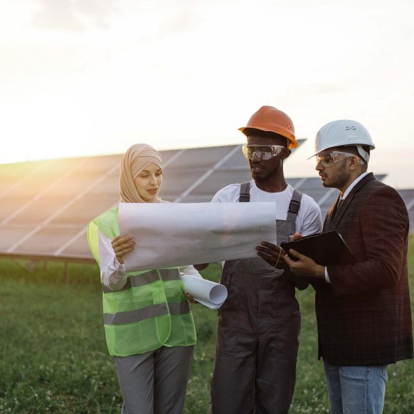multi-ethnic-people-discussing-work-at-solar-stati-HFXPKUV.jpg